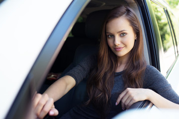 Fototapeta na wymiar Beautiful young happy woman in car.