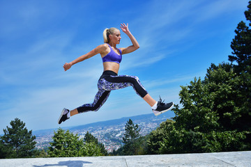 Young woman joyfully jumping in Park