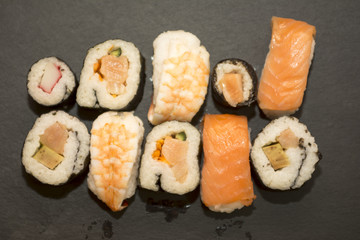 Pieces of sushi on a black stone