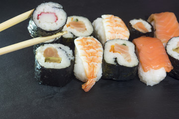 Pieces of sushi on a black stone