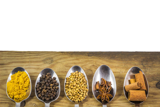 spices in spoons on wooden in white background. Food ingredients spices.