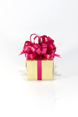 Gold gift box with red ribbon isolated on white background