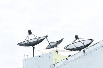 Satellite dish on the old building with the blue sky background in the morning