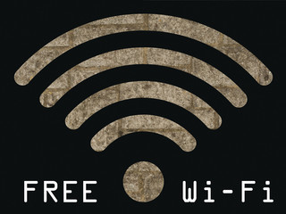 Free WIFI sign with old stonework wall visible through graphics 