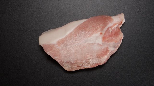 TIME-LAPSE: Freezing a pork steak on black table