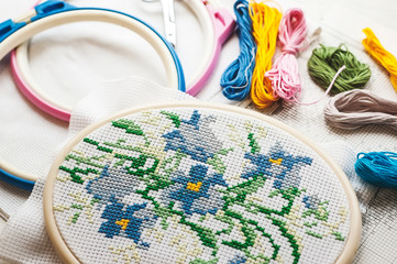 Cross-stitch set : hoop with embroidered flowers pattern, scissors, canvas and colorful yarn....