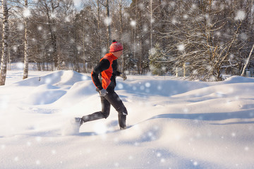 Fototapeta na wymiar Running man in snow. Winter outdoor trail runner