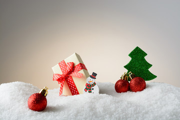 Fototapeta na wymiar Christmas Decoration Snowman and tree in the snow