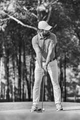 golf player hitting shot with club