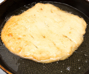 tortilla is fried in a pan