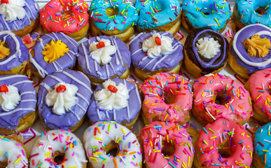 Colorful donuts on bakery display for Hanukkah celebration. Selective focus.