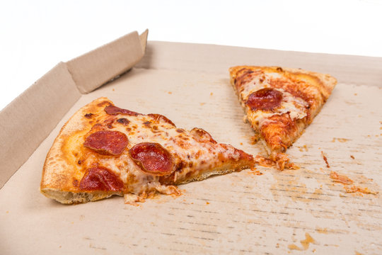 Leftover pizza in box isolated on white background