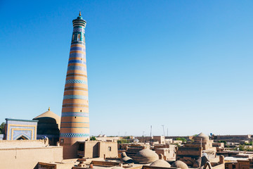 The architecture of Itchan Kala, the walled inner town of the city of Khiva, Uzbekistan. Khoja Minaret. UNESCO World Heritage