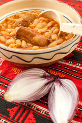 traditional cuisine beans with sausage and red onion
