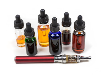 Assorted flavors of vape juice and an ecigarette isolated on white background
