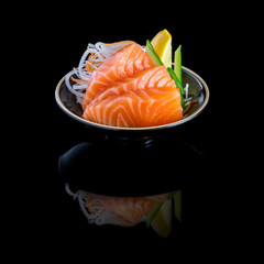 sashimi with tuna in a black plate. On a black background. - obrazy, fototapety, plakaty