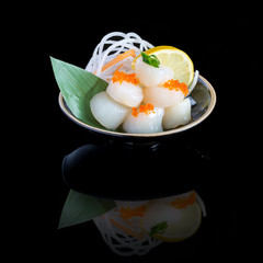 sashimi with tuna in a black plate. On a black background. © popovich22