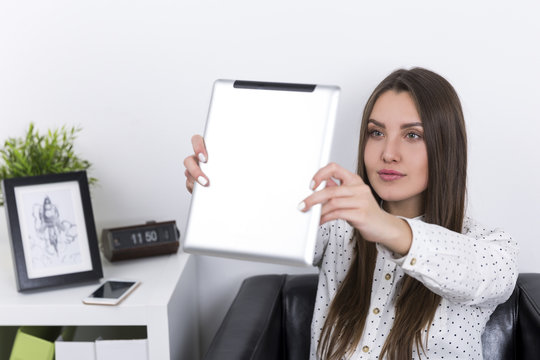 Portrait of woman in polka dot shirt making selfie