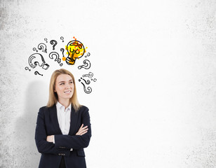 Blond woman with crossed arms and glowing light bulb with questi
