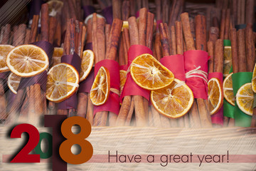 Winter holidays greeting card for 2017 to come. Descrete Blurry background with seasonal winter spice decorations.