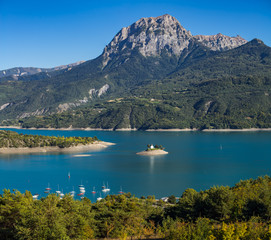 Fototapeta na wymiar View of the Grand Morgon peak (Pic de Morgon) on Summer afternoon. The Saint Michel Bay (with the Chapel) and Serre Poncon Lake. Hautes Alpes, Southern French Alps, France