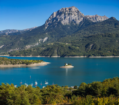 View of the Grand Morgon peak (Pic de Morgon) on Summer afternoon. The Saint Michel Bay (with the Chapel) and Serre Poncon Lake. Hautes Alpes, Southern French Alps, France