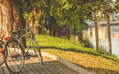 Naklejka na ściany i meble bicycle standing next to river