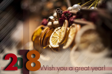 Winter holidays greeting card for 2017 to come. Descrete Blurry background with seasonal winter spice decorations.