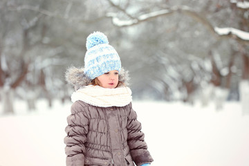 Fototapeta na wymiar Cute little girl in park on winter day
