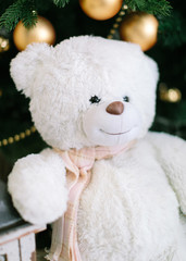 Christmas tree decorations. Toy bear near a cristmas tree.