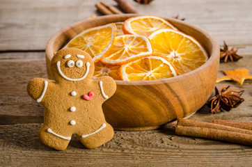 Christmas decoration with oranges and gingerbread on wooden background