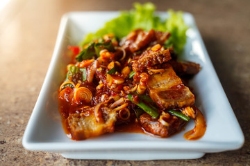 Crispy pork spicy in rectangle dish,Selective focus.