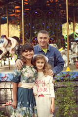 Fototapeta na wymiar A normal happy family posing in the Park mom, dad and daughter 1