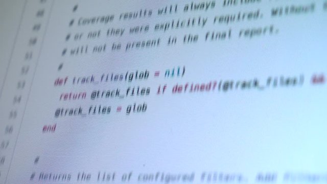 Programming code running down a computer screen terminal
