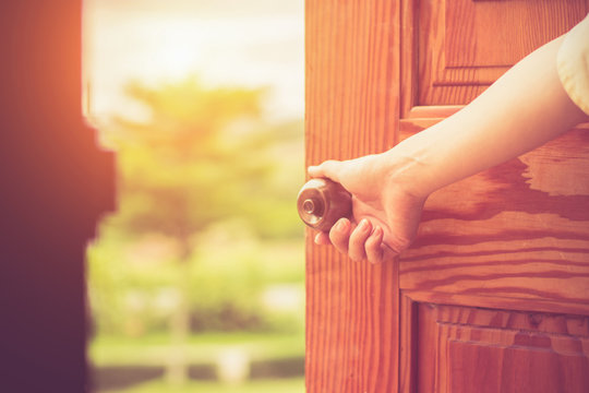 Women hand open door knob or opening the door.