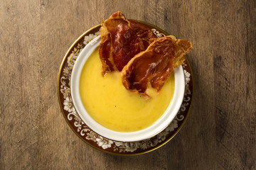 Pumpkin Soup with proschiuto on table