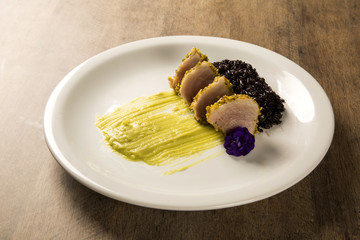 Tuna with pistachio crust, black rice and avocado puree
