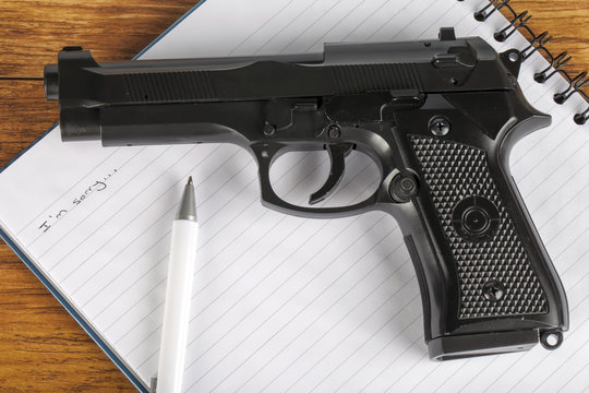 Concept of suicide note with gun