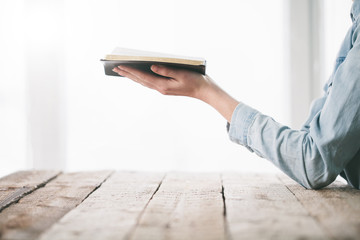 Woman reading and praying over Bible