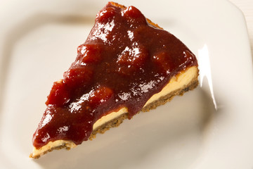 Cheesecake with brazilian goiabada jam of guava on plate on tabl