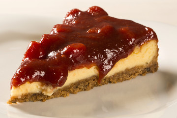 Cheesecake with brazilian goiabada jam of guava on plate on tabl