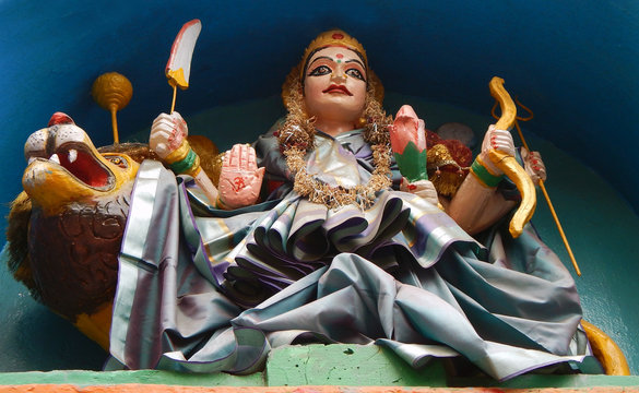 Hindu goddess Durga idol on a temple with different kinds of weapons to kill the demon