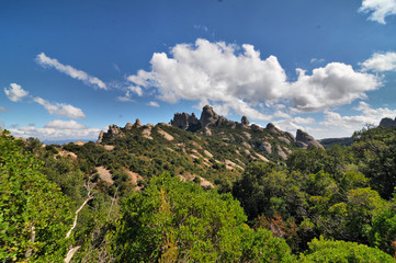 Montserrat  - multi-peaked rocky range located near the city of Barcelona in Catalonia, Spain.
