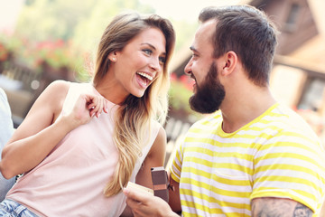 Young man proposing to beautiful woman outdoors