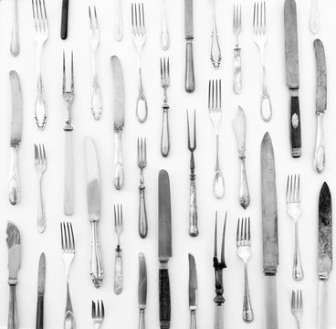 silver cutlery - vintage knife and fork on white background 