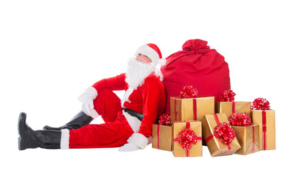 Santa Claus near big red Christmas sack full of gift boxes