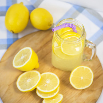 Lemonade in a transparent cup with handle