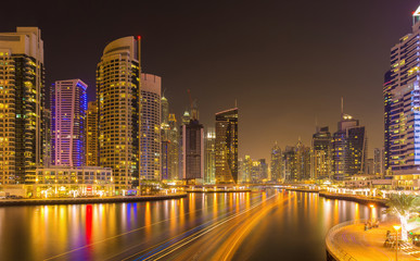 Fototapeta na wymiar Modern skyscrapers in luxury Dubai Marina with busy canal in the evening,Dubai,United Arab Emirates