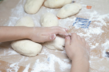 child prepares the dough of flour for pasta pastry bread