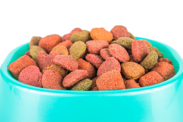 Dry dog treats in bowl isolated on white